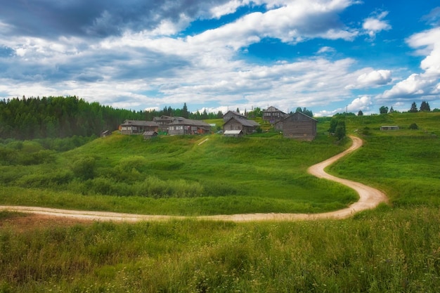 Beautiful village on a hill with wooden houses in the Arkhangelsk region in summer in Russia