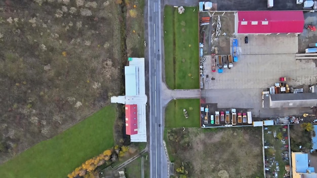 Beautiful village house in a small village in top aerial view small green village from above with fields