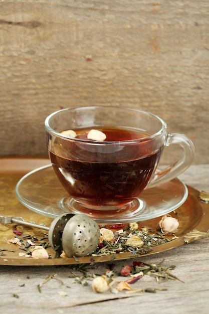 Beautiful vintage composition with herbal tea on wooden table