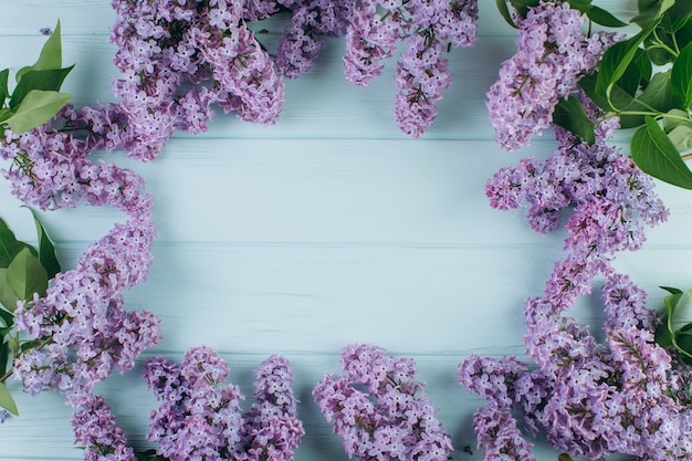 Photo the beautiful violet lilac around a blue wooden background