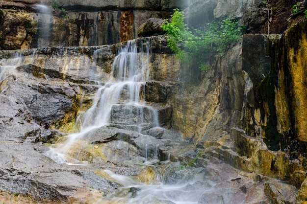 Beautiful waterfall on small river in a park