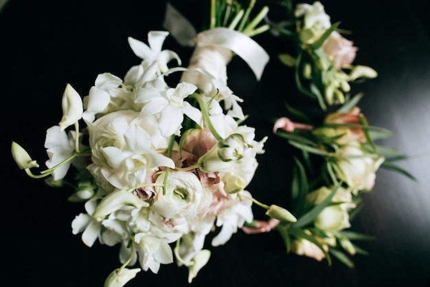 A beautiful wedding bouquet of brides from white flowers on a dark wooden backgroundx9