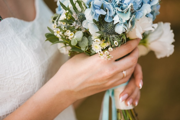 Beautiful wedding bouquet of flowers in bride's hands