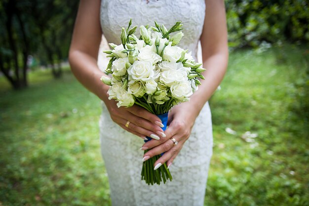 Beautiful wedding bouquet in hands of the bride