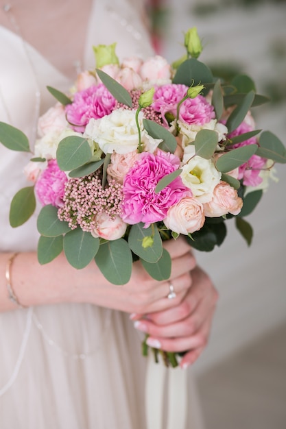 Beautiful wedding bouquet in hands of the bride