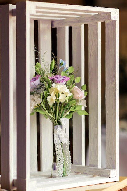 Beautiful wedding bouquet made of polymer clay white lies in a wooden box