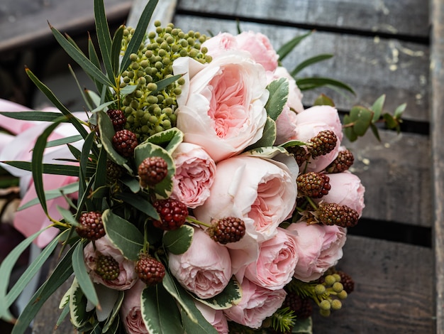 Beautiful wedding bouquet of shrub and peony gently pink roses.