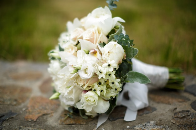 Beautiful wedding bouquet of white roses and hydrangeas