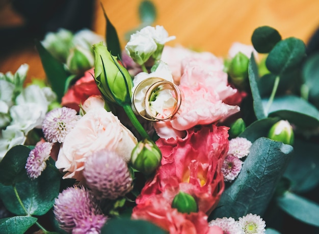 Beautiful wedding bouquet with golden rings