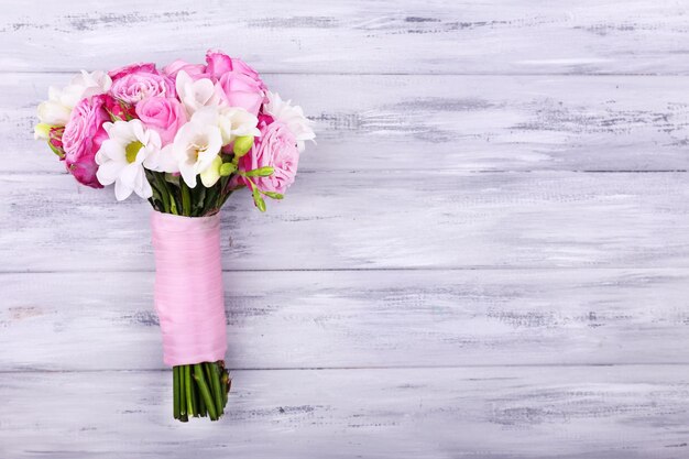 Beautiful wedding bouquet on wooden background