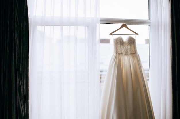 Beautiful wedding dress for the bride on the windowx9