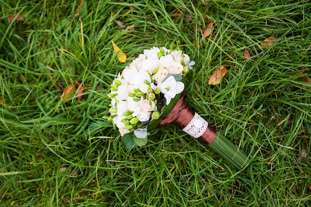 Beautiful wedding flowers bouquet on the green grass.