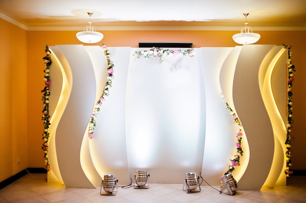 Beautiful wedding set decoration in the restaurant. Luxury photo zone.