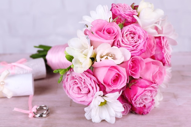 Beautiful wedding still life with bouquet on grey wall background