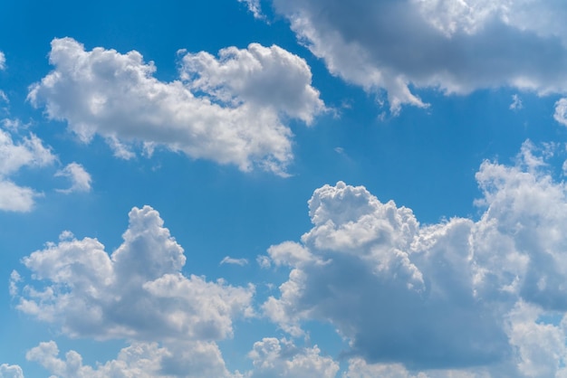 Beautiful white clouds on a bright blue background