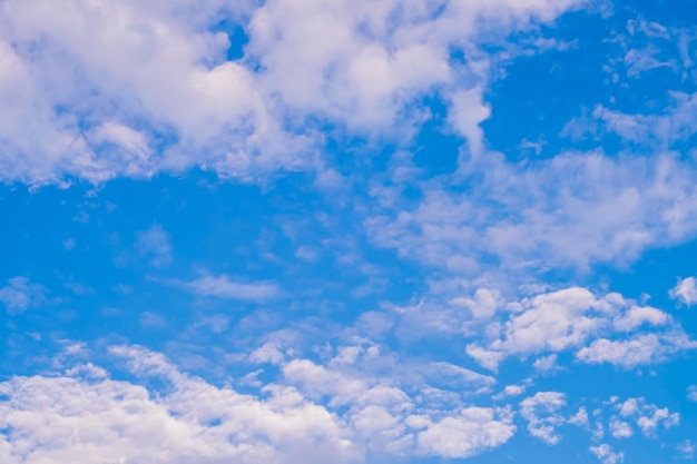 Beautiful white fluffy and cirrocumulus clouds on a blue sky background