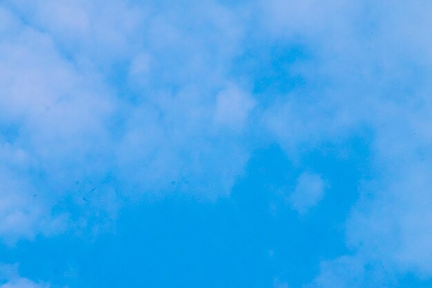 Beautiful white fluffy and cirrocumulus clouds on a blue sky background