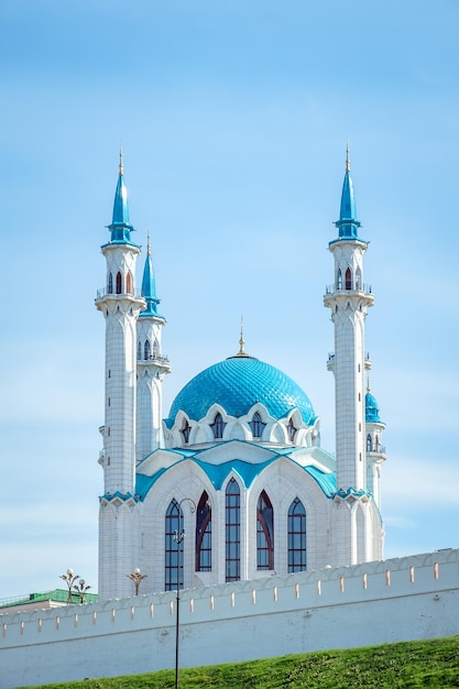 Beautiful white mosque with a blue roof against the blue sky on a sunny summer day.