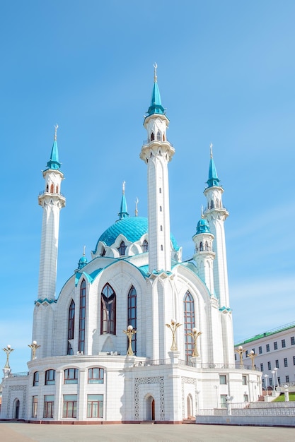 Beautiful white mosque with a blue roof against the blue sky