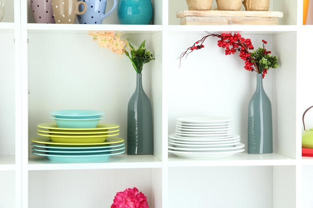 Beautiful white shelves with tableware and decor