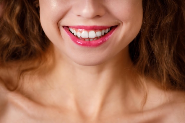 Beautiful wide smile of young woman with healthy white teeth