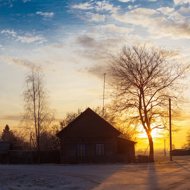 Beautiful winter frozen rural landscape at sunset