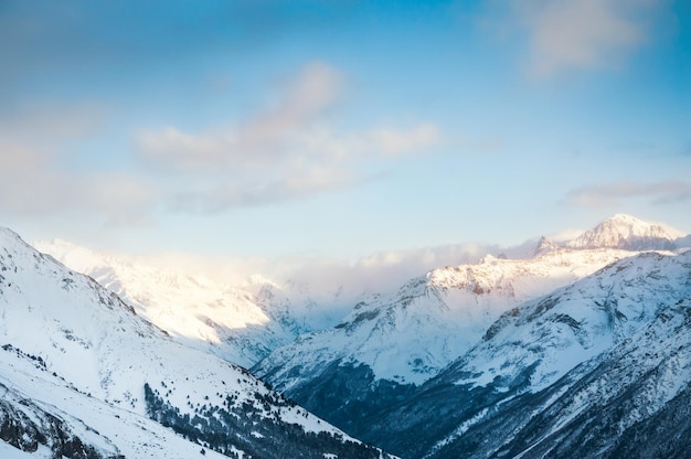 Beautiful winter landscape of snow-covered mountains at sunset