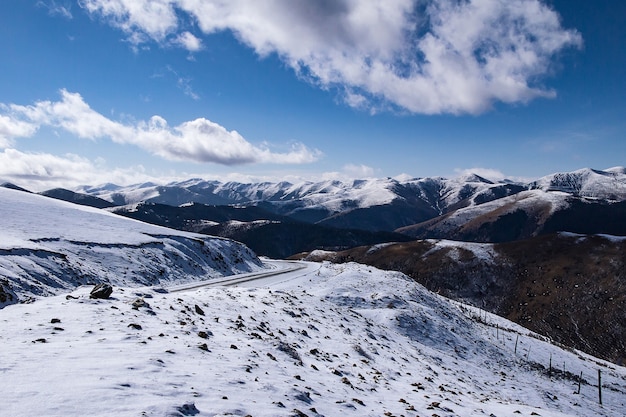 Beautiful Winter landscape, Snow Covered Road and Snowy Mountains