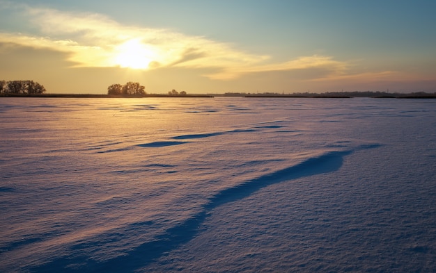 Beautiful winter landscape with lake and sunset sky. Composition of nature.