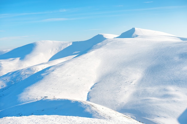 Beautiful winter landscape with snow mountains under blue sky