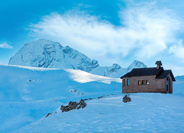 Beautiful winter mountain landscape with chapel on hill top