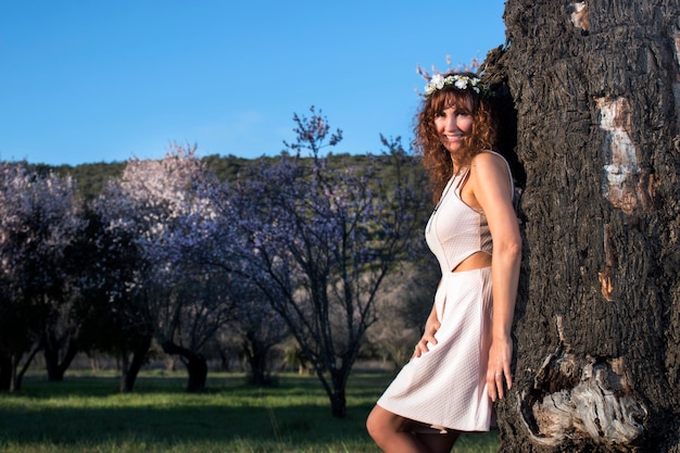 Beautiful woman next to a almond tree