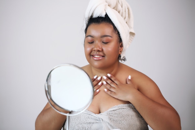 Beautiful woman in bathrobe ready to apply makeup