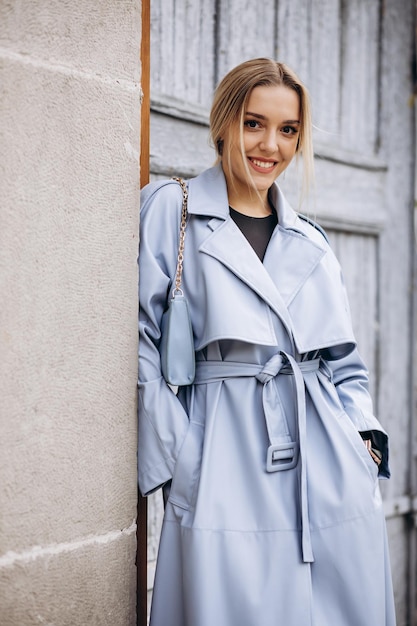 Beautiful woman in blue coat walking in the street