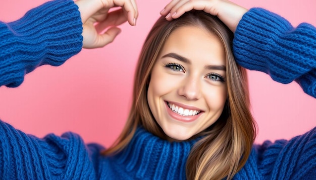 Photo beautiful woman in a blue sweater on a pink background