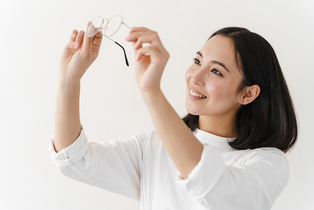 Beautiful woman checking the cleanliness of glasses