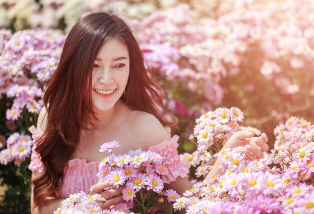 beautiful woman in chrysanthemum glower garden