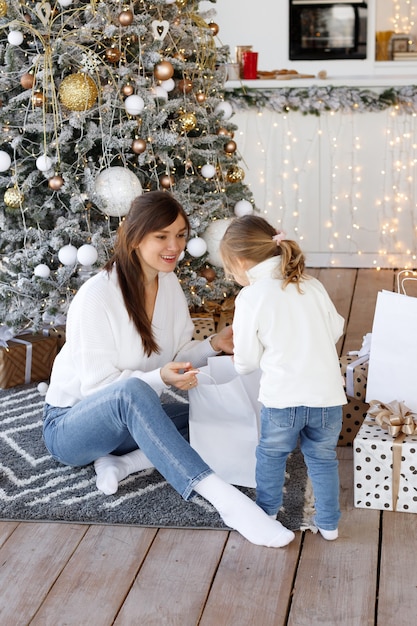 Beautiful woman and daughter on Christmas