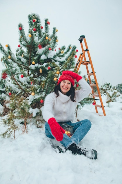 Beautiful woman decorating christmas tree