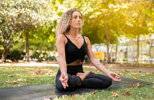 Beautiful woman doing yoga on the street