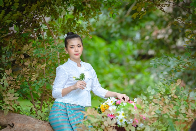 Beautiful woman dressed in traditional costume in the forest