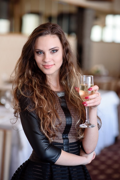 Beautiful woman drinking champagne in a restaurant