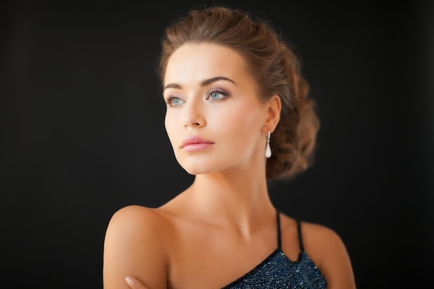 beautiful woman in evening dress wearing diamond earrings