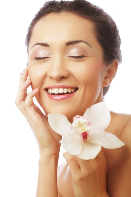 Beautiful woman face with orchid flower