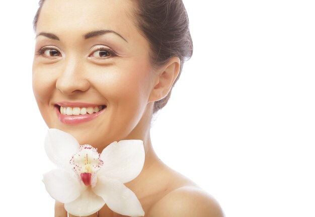 Beautiful woman face with orchid flower