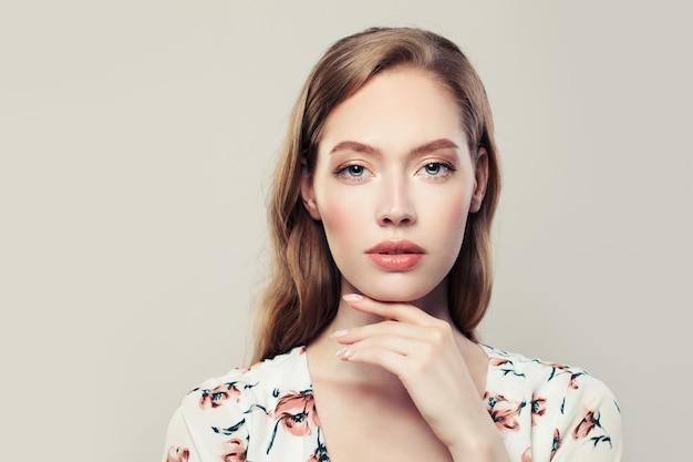 Beautiful woman face with perfect natural makeup and hair on white background