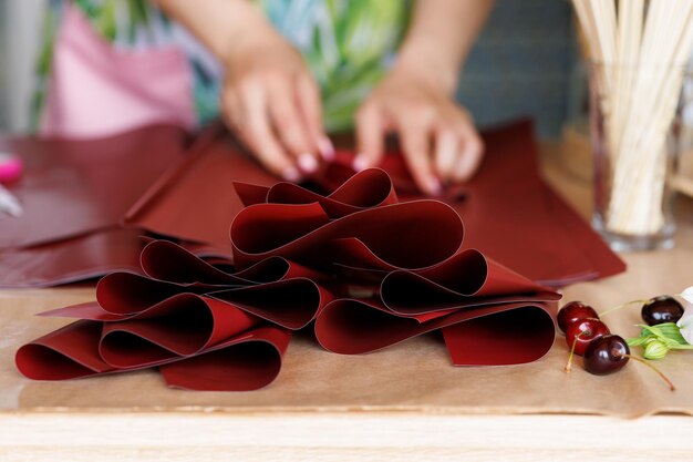 Beautiful woman foodflower makes an elegant bouquet with flowers and berries