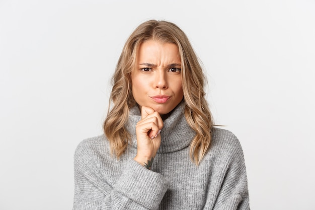 Beautiful woman in a grey sweater posing