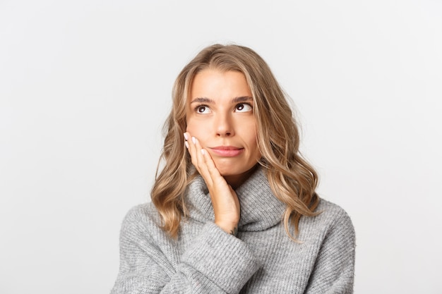 Beautiful woman in a grey sweater posing