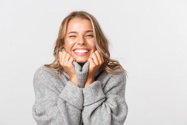 Beautiful woman in a grey sweater posing